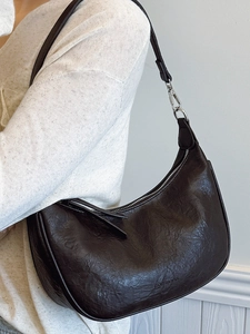 Minimalist black crescent shoulder bag in premium leather finish for stylish women