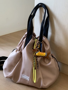Fashion nylon drawstring backpack in dusty rose with yellow cords and a cute dog pendant