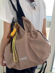 Khaki nylon drawstring backpack for women with puppy charm and fashion patch detail