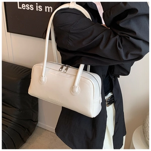 Detailed view of white faux leather boston bag with fine texture and branded logo