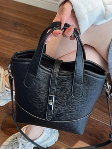Black pebbled leather tote bag with silver twist lock and removable shoulder strap