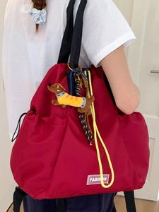 Fashionable red nylon drawstring backpack with black straps and dachshund pendant charm