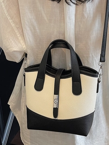 Minimalist black and white contrast canvas tote bag with metal twist lock for daily commute