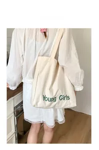Detail of Young Girls green embroidery on cream large capacity canvas tote bag