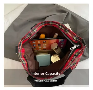 Macro view of plaid tote bag interior showing large capacity for gadgets and cosmetics