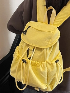 Minimalist yellow nylon backpack with multi-pocket design for school and travel