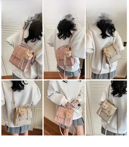 Detailed views of vintage style crossbody bag with plush bear charm and ribbon accent