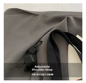 Detail of adjustable black nylon strap with durable plastic buckle on canvas tote bag