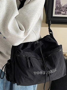 Minimalist black nylon crossbody bag with drawstring design and large capacity for women