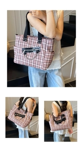 Detail of pink and black plaid tote bag with decorative metal chains and side pocket