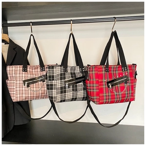 Detailed view of punk plaid tote bags with metal chains and leather zipper pockets