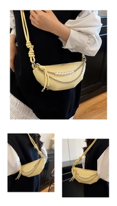 Detail showing woven texture on pale yellow crescent bag with pearl and silver chains