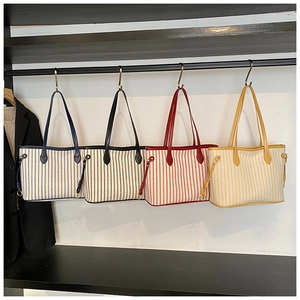 Detailed comparison of canvas tote bags in dark blue, black, red, and yellow stripes