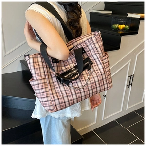 Detail of pink plaid gothic tote bag featuring metal chains and stylish leather zip pocket