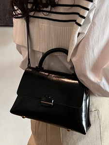Chic black glossy patent leather small square handbag with crossbody strap and gold hardware