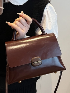 Fashionable dark red glossy patent leather handbag for women with gold feet and top handle