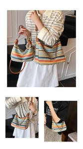 Detail of bohemian woven stripe tote bag with leather handles and chain strap