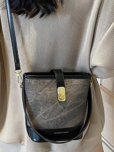 Women's chic grey distressed canvas bucket bag with black leather trim and gold lock