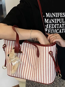 Striped canvas tote bag with red leather handles and a cute puppy plush charm for women