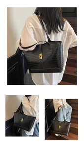 Close-up of black crocodile pattern tote bag with a golden square lock and spacious design