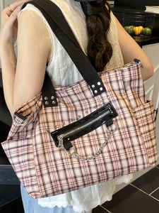 Punk style pink plaid tote bag with silver studs and chain details on shoulder