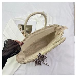 Detailed top view showing the woven straw bag interior with zipper and silk scarf