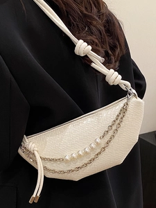 Minimalist white woven crescent bag with pearl chain and knotted shoulder strap