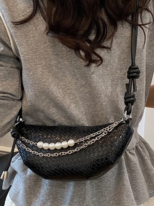 Black woven half-moon crossbody bag with pearl chain detail and knotted leather strap