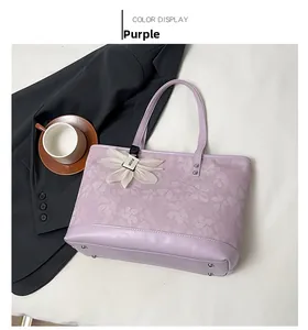Detailed close-up of a purple lace tote bag with a white flower pendant and leather strap
