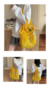 Detail of yellow knit mesh tote bag with colorful starfish patches and blue silk bow detail