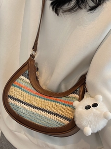 Rainbow woven straw hobo bag with brown leather trim and cute plush charm pendant