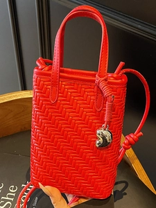 Red woven leather mini tote bag with short handles and silver heart charm pendant