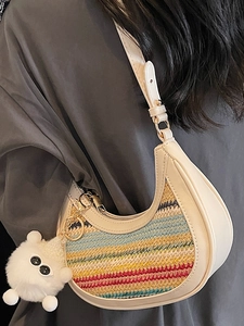 Rainbow woven half-moon crossbody bag with cream leather strap and plush charm detail