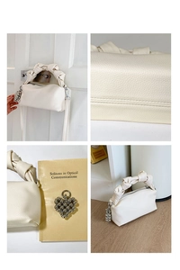 Detail of cream pleated mini bag with knotted handle and heart bead charm accessory