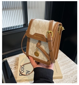 Detailed close-up of retro quilted mini crossbody bag with gold hardware and logo
