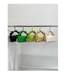 Detail showing five colorful wrinkled handbags with heart-shaped beaded pendants and knotted handles