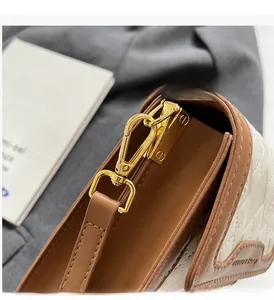 Detailed macro view of gold metal hardware and quilted leather texture on luxury bag