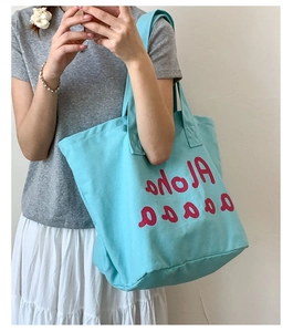 Detail of light blue canvas tote bag showing red Aloha print and summer wave pattern