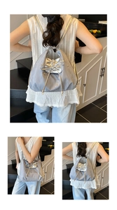 Detail view of silver drawstring backpack with metallic bow and pleated texture