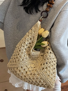Handwoven straw tote bag with wooden bead straps and hollow crochet for summer vacations