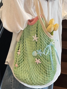Light green crochet mesh shoulder bag with pink trim and seashell charms for summer