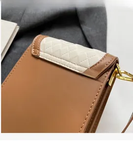 Detail view of the mini crossbody bag showing brown texture and white quilted pattern