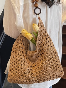 Summer woven hollow straw tote bag with decorative wooden beads and shoulder strap