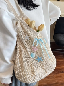 Chic beige knit shoulder bag with blue ribbon bow and starfish charms for summer vacations