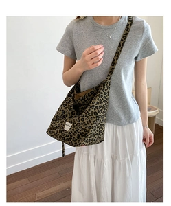 Detail view of large leopard print canvas tote bag with UR FAVE label and wide strap
