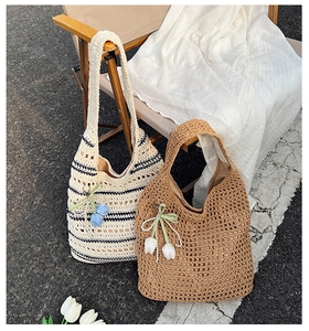 Close-up of hollow crochet tote bags with floral charms and pearl strands detail