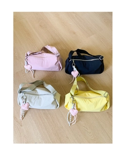 Four colorful canvas pillow bags in pink black beige and yellow with heart charms