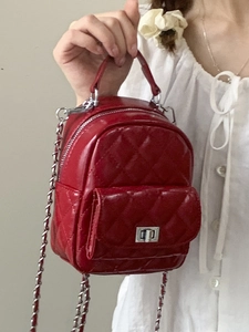 Red quilted leather mini backpack with silver chain strap and top handle for women