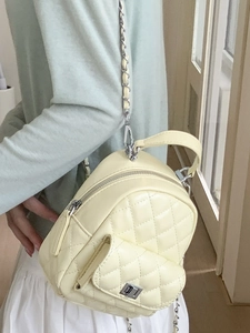 Quilted mini backpack in creamy yellow with silver chain straps and top handle for women