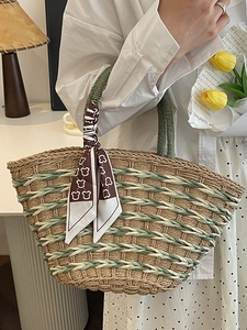 Handmade woven straw tote bag with green accents and a brown bear print silk scarf